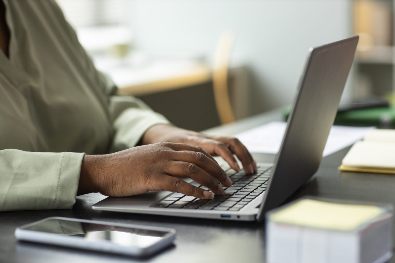 Side View Worker Typing Laptop via Freepik